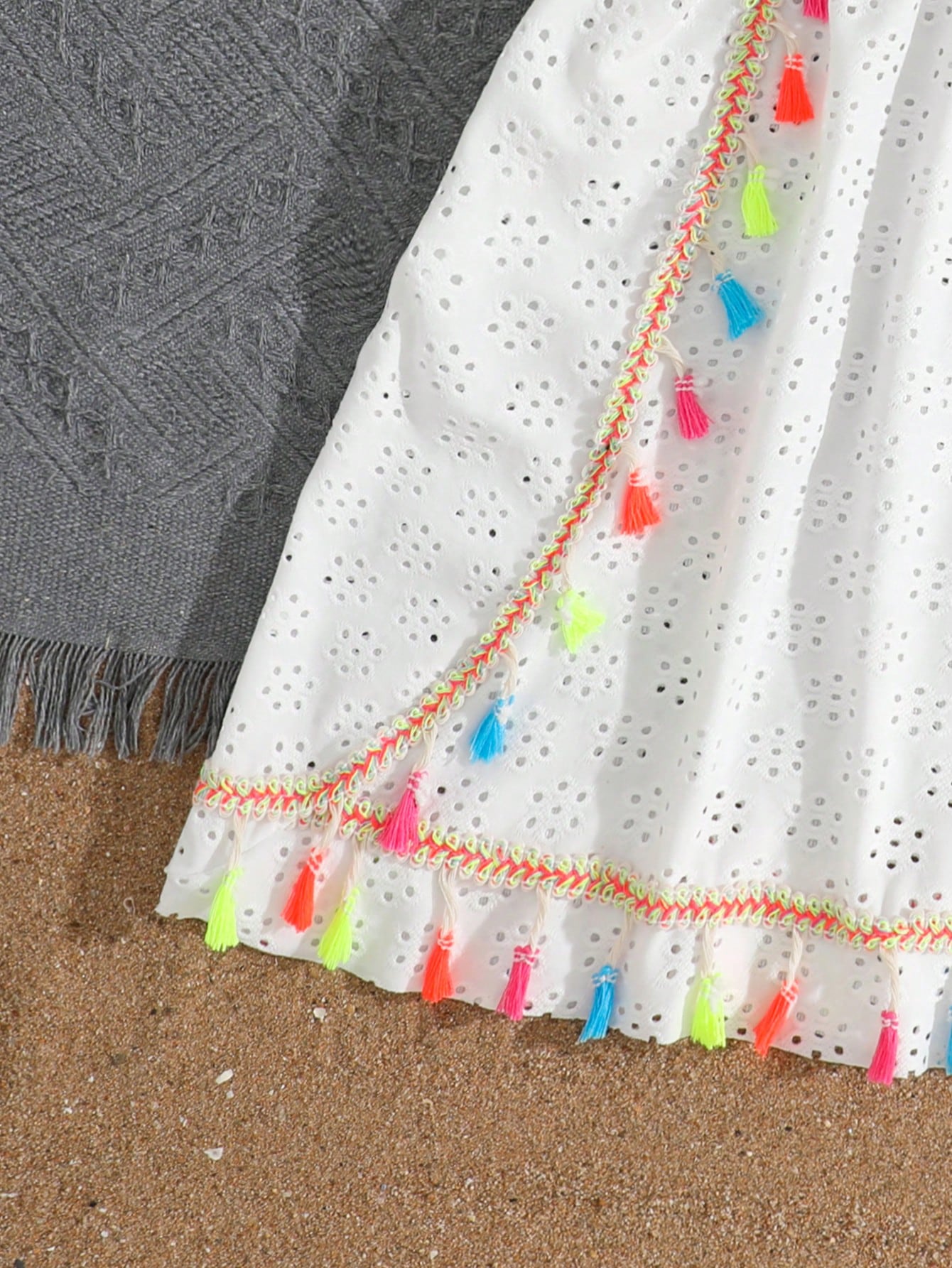 White tween girls swimsuit cover-up with V neck, short sleeves, contrast lace, fringe details, and regular length mesh fabric for beachwear