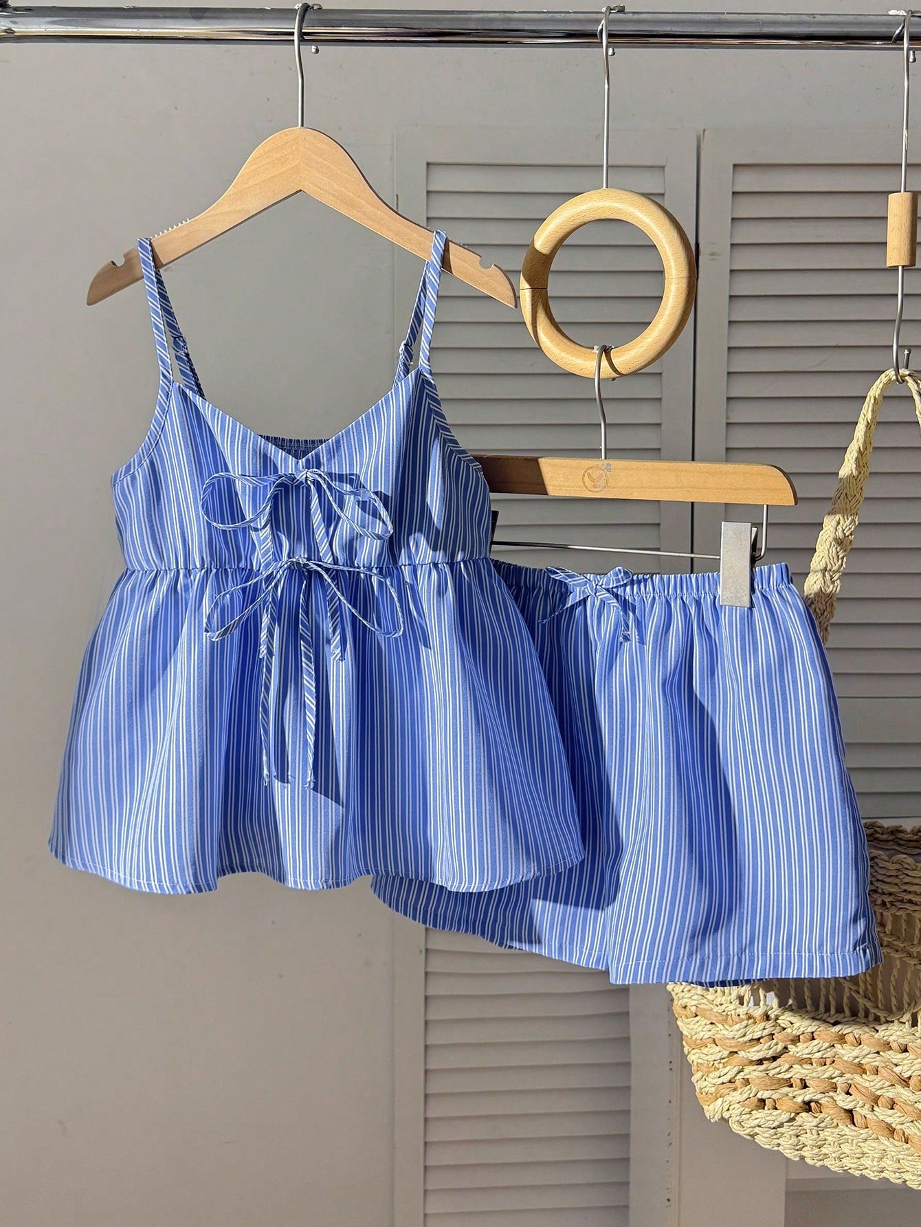 Tween girl 2-piece summer set with a black and white sleeveless striped spaghetti strap tank top with ruffle details and matching casual shorts.