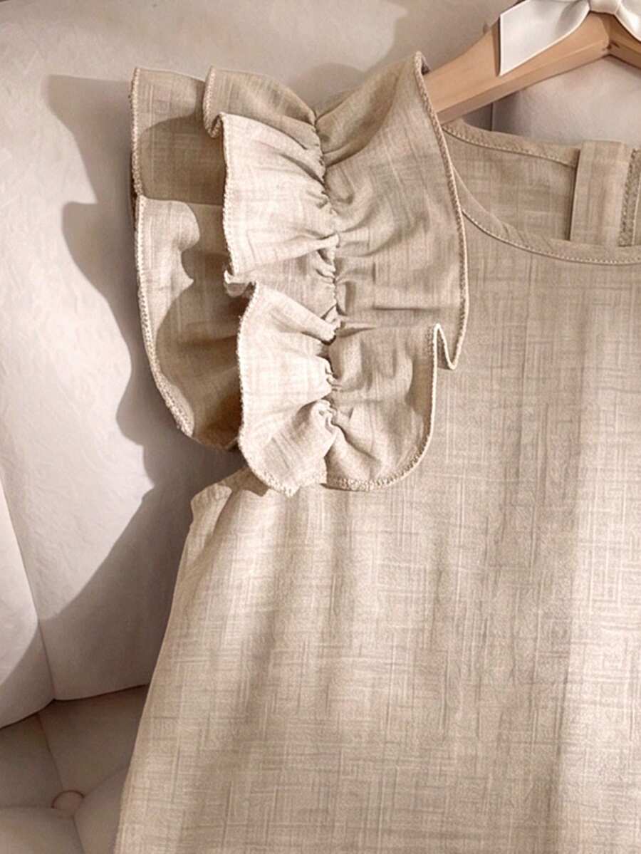 Tween girls apricot vacation midi dress featuring a round neck, cut out details, ruffle flounce accents, and geometric pattern.