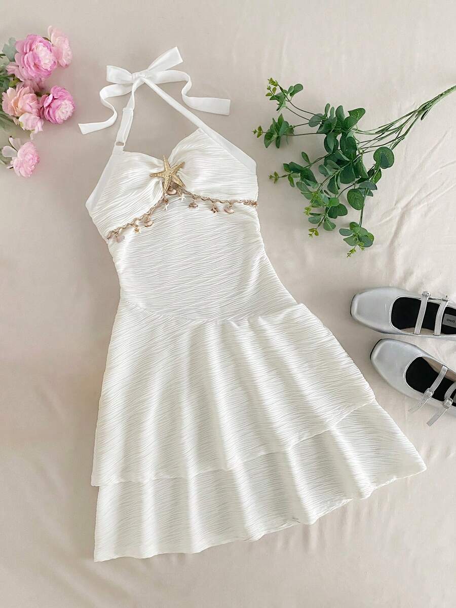 Tween girls apricot sleeveless halter mini dress with textured starfish and shell decor, shirred tiered layer, high waist, and flounce hem.