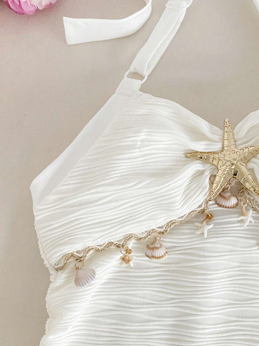 Tween girls apricot sleeveless halter mini dress with textured starfish and shell decor, shirred tiered layer, high waist, and flounce hem.