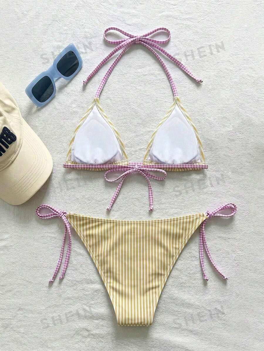 Women's black and white zebra print two-piece bikini set featuring a high waist tie-side bottom and a backless halter top with removable padding.