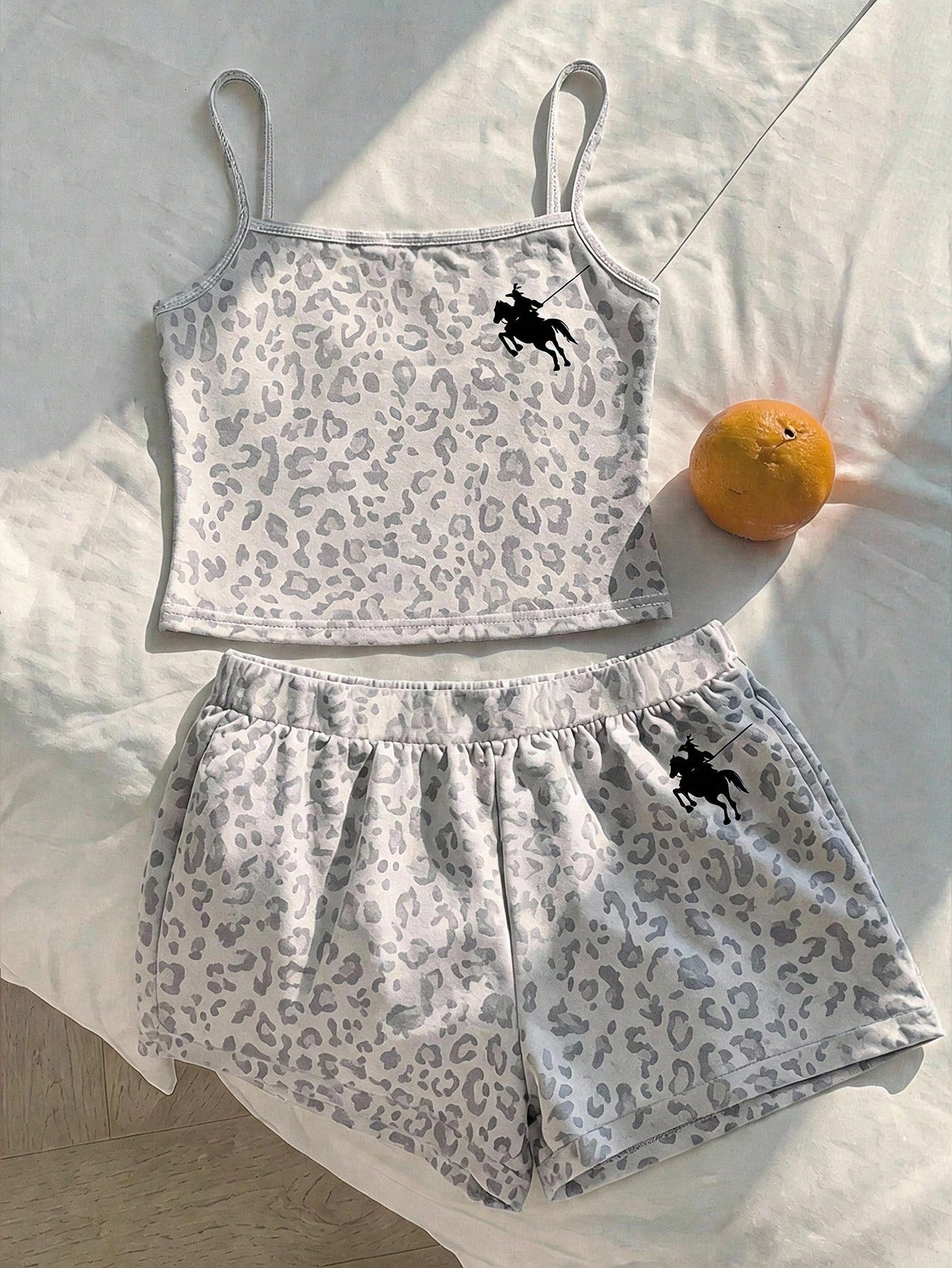 Tween girls summer 2-piece Hawaiian style outfit featuring a graphic print spaghetti strap camisole top with contrast piping and matching casual shorts.