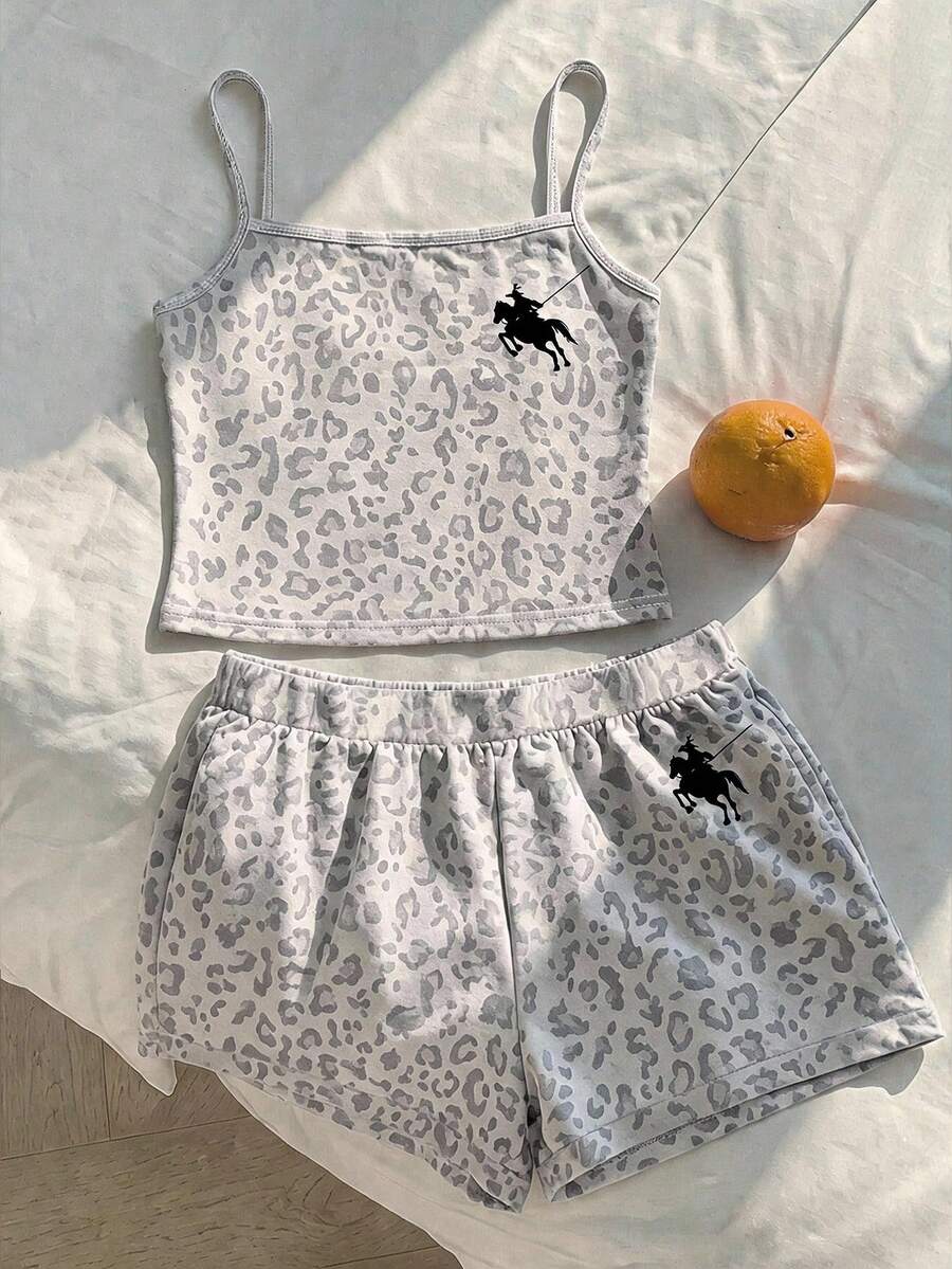 Tween girls summer 2-piece Hawaiian style outfit featuring a graphic print spaghetti strap camisole top with contrast piping and matching casual shorts.