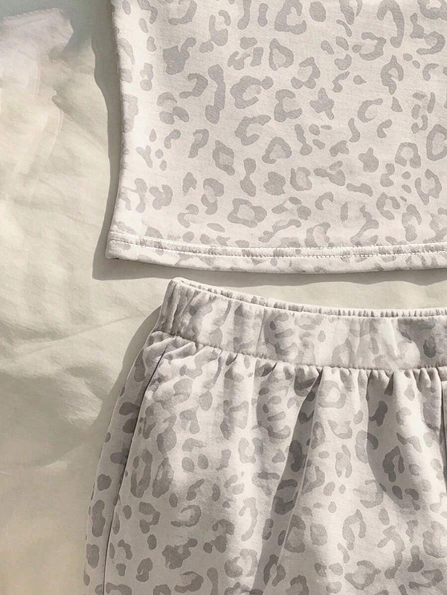 Tween girls summer 2-piece Hawaiian style outfit featuring a graphic print spaghetti strap camisole top with contrast piping and matching casual shorts.