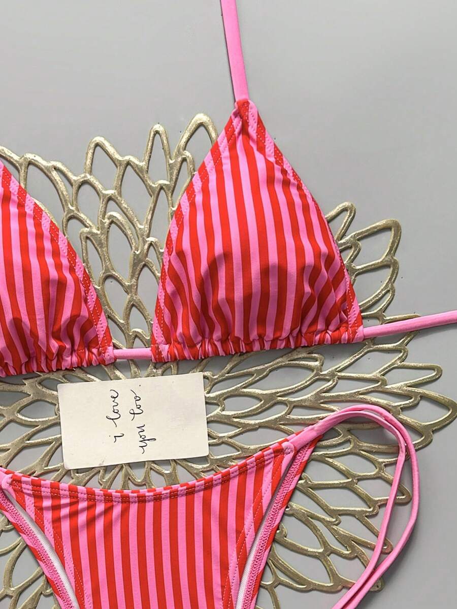 Women's black halter bikini set featuring triangle cups with gold bead decor and tie-back closure
