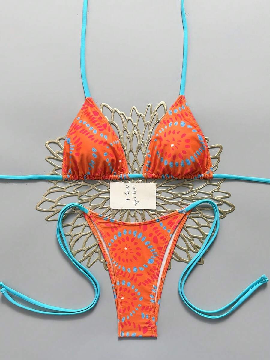Women's black halter bikini set featuring triangle cups with gold bead decor and tie-back closure