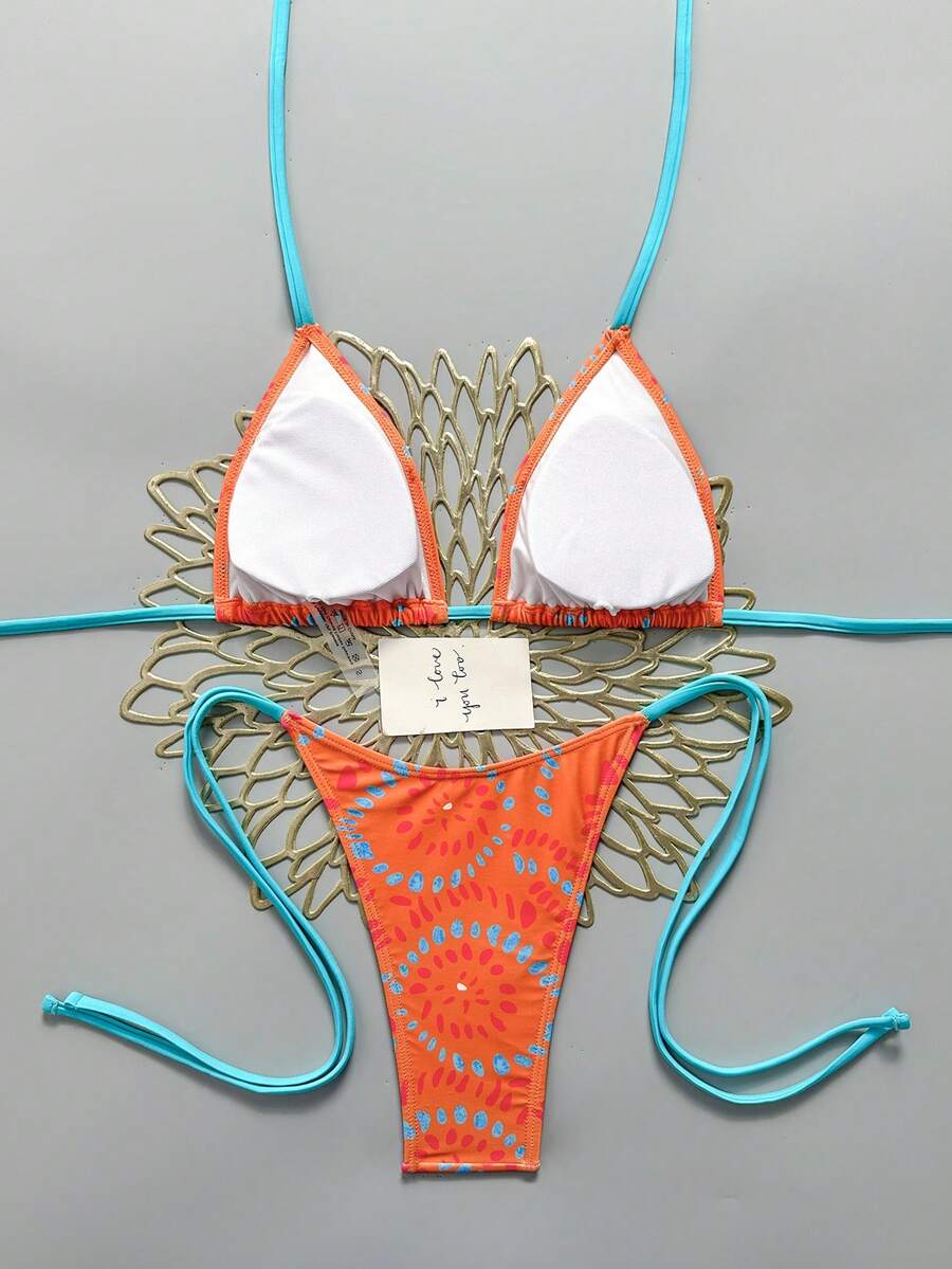 Women's black halter bikini set featuring triangle cups with gold bead decor and tie-back closure
