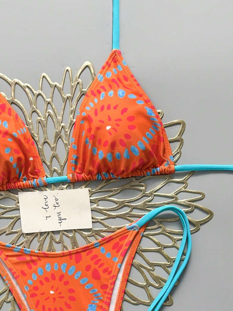 Women's black halter bikini set featuring triangle cups with gold bead decor and tie-back closure