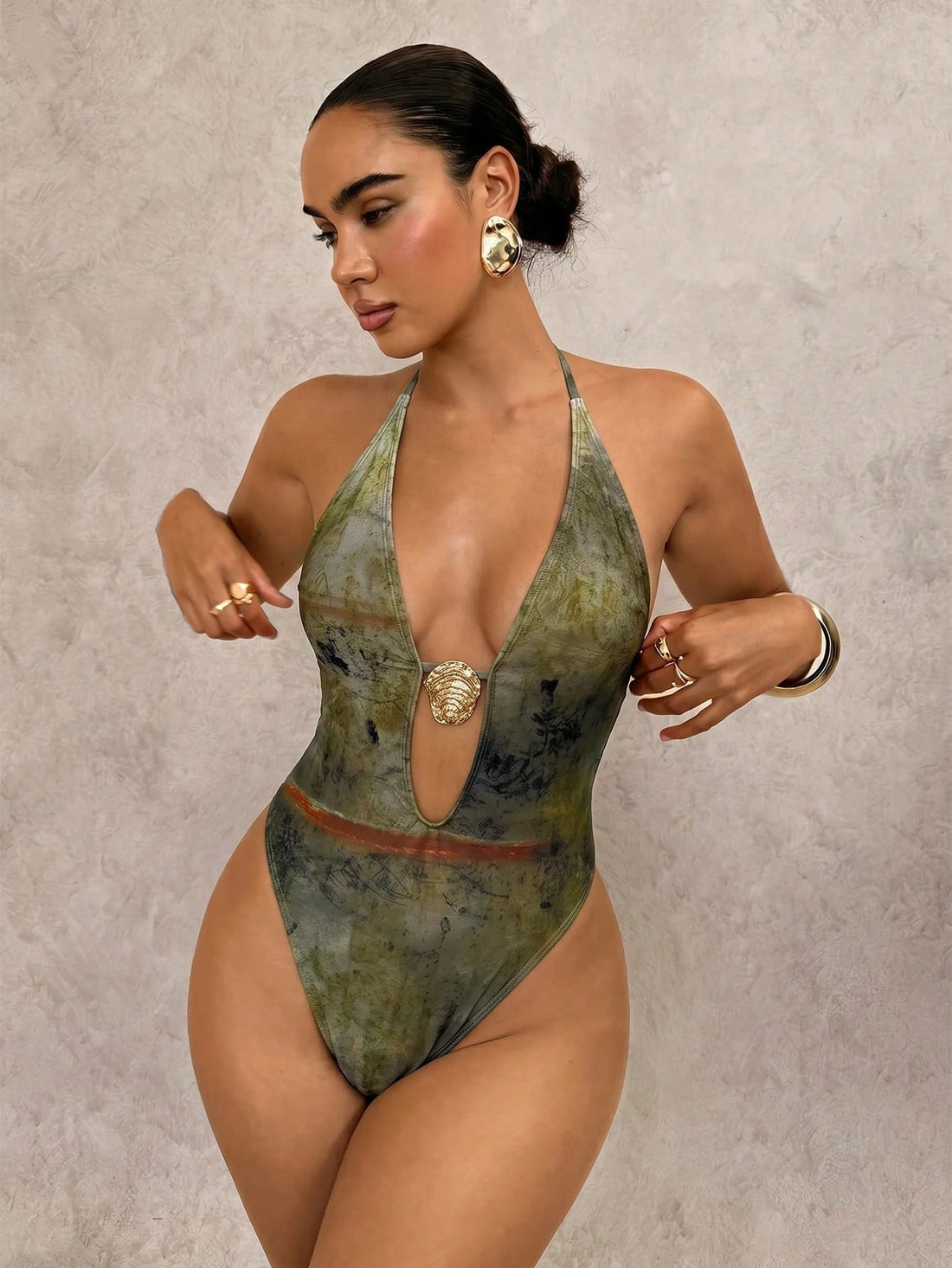 DivaQ army green printed halter one-piece swimsuit for women featuring a backless cut-out design, high-cut leg, and wireless padded cups.