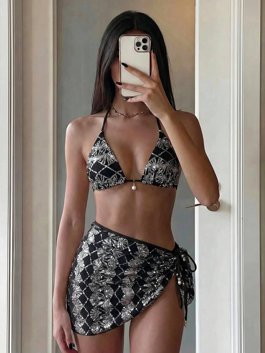 Women's 3-piece blue tropical shell print bikini set featuring a halter bralette top, low-waist tie-side bottom, and a matching sheer mesh cover-up skirt.