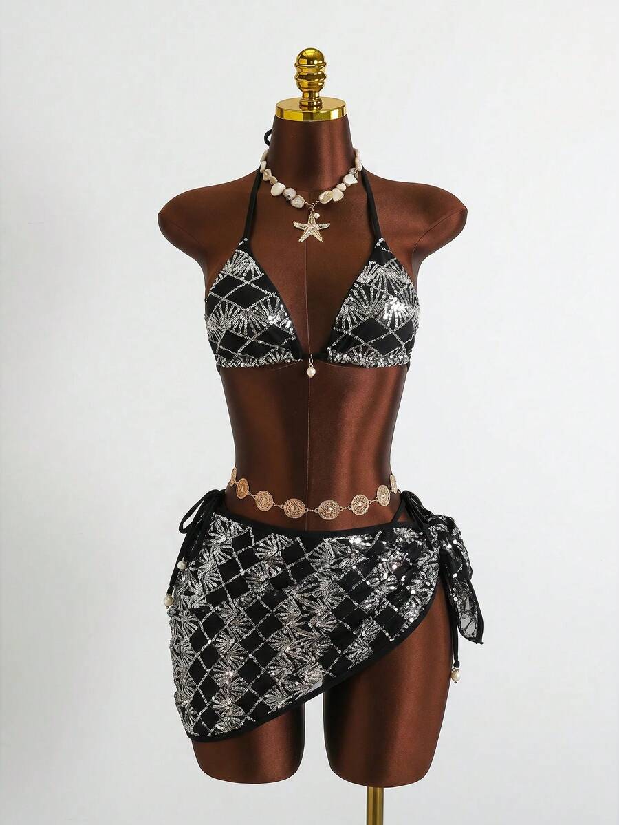 Women's 3-piece blue tropical shell print bikini set featuring a halter bralette top, low-waist tie-side bottom, and a matching sheer mesh cover-up skirt.