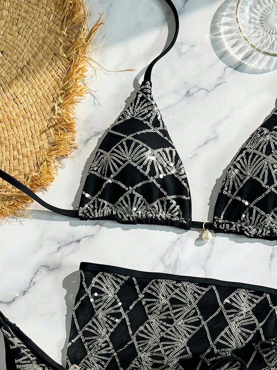 Women's 3-piece blue tropical shell print bikini set featuring a halter bralette top, low-waist tie-side bottom, and a matching sheer mesh cover-up skirt.