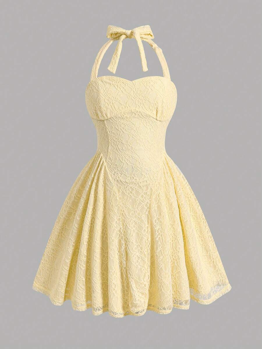 Black and white polka dot cami dress for tween girls featuring a square neckline, high waist, and flared short A-line hem.