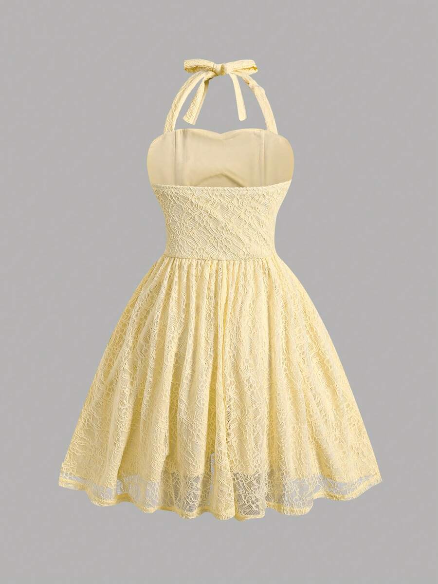 Black and white polka dot cami dress for tween girls featuring a square neckline, high waist, and flared short A-line hem.