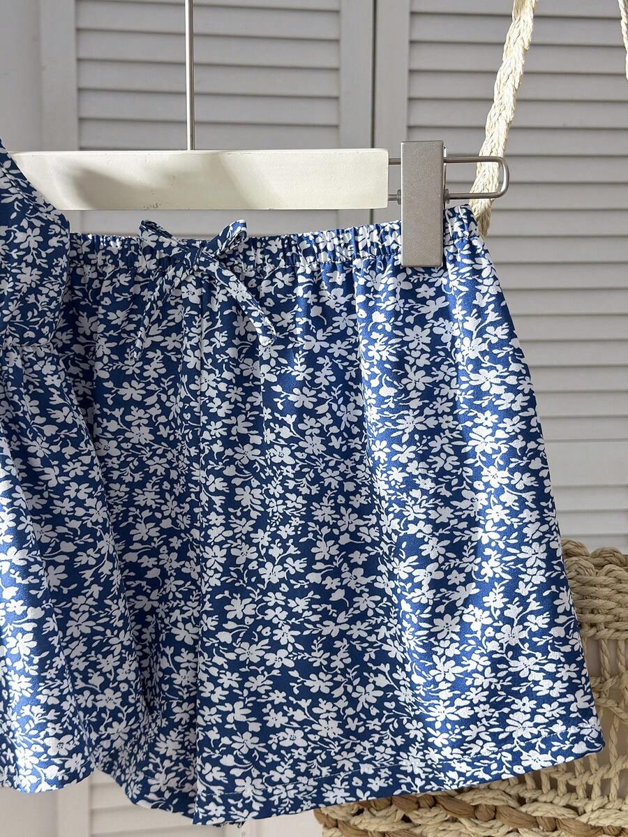 Tween girl 2-piece summer set with a black and white sleeveless striped spaghetti strap tank top with ruffle details and matching casual shorts.