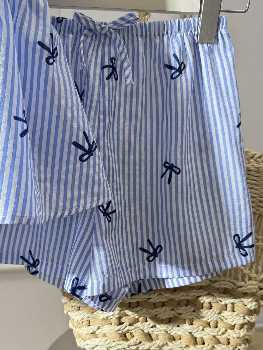 Tween girl 2-piece summer set with a black and white sleeveless striped spaghetti strap tank top with ruffle details and matching casual shorts.