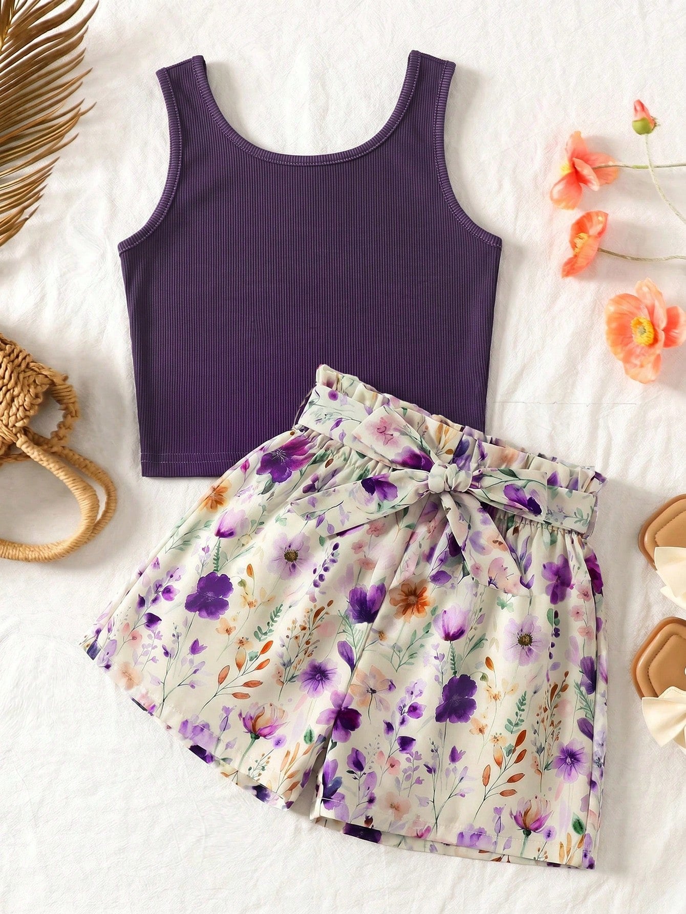 Tween girls 2-piece summer set featuring a turquoise blue ribbed tank top and tropical leaf pattern belted shorts.