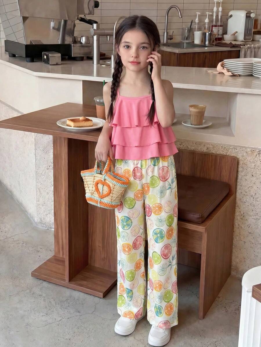 Tween girls blue 2-piece vacation outfit set featuring a tiered ruffle spaghetti strap camisole and loose high-waist pants.