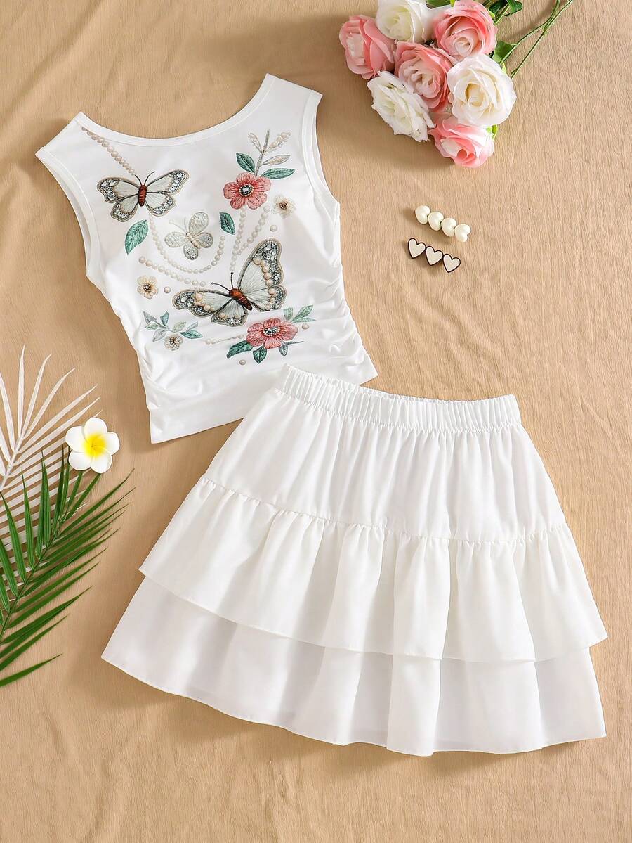 Light blue two-piece outfit set for tween girls with a sleeveless round neck vest top and a tiered ruffle cake skirt featuring a plant pattern.