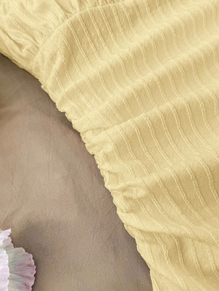 Tween girl yellow mini sundress with large pink floral hibiscus print, spaghetti straps, high waist, flared hem, and sleeveless cami style for summer beach wear