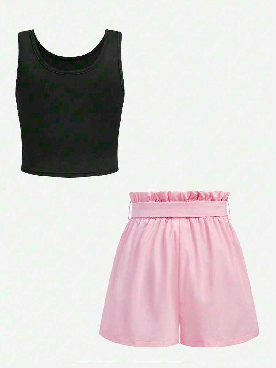 Tween girl wearing a casual 2-piece set featuring a black rib-knit scoop neck tank top and leopard print paperbag waist shorts with a matching belt.