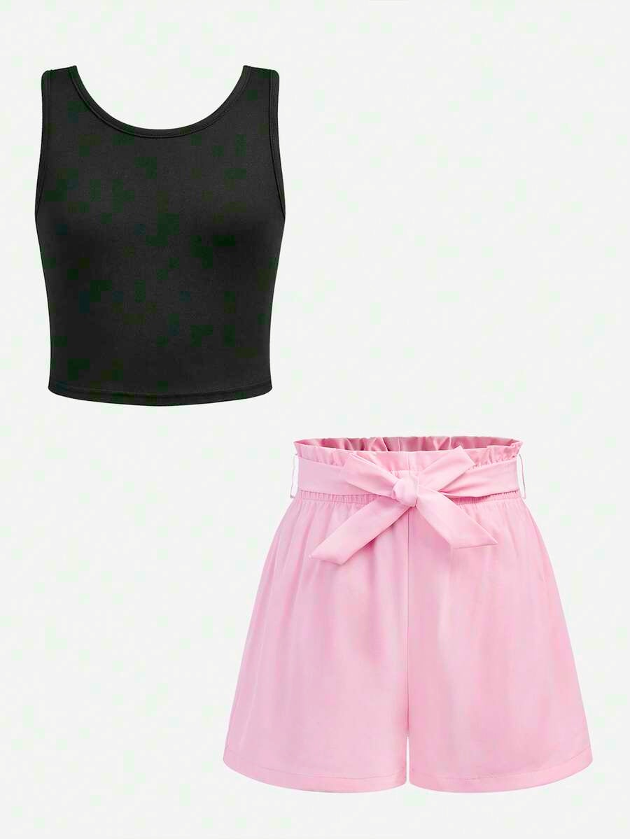 Tween girl wearing a casual 2-piece set featuring a black rib-knit scoop neck tank top and leopard print paperbag waist shorts with a matching belt.