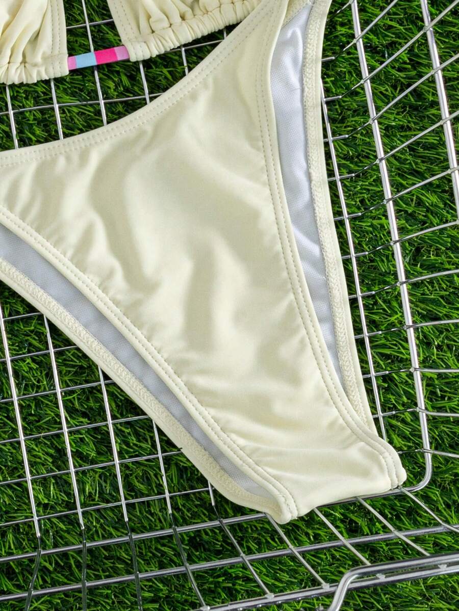 Women's striped halter bikini top with removable padding and matching tie-side low-waist swimsuit bottoms.