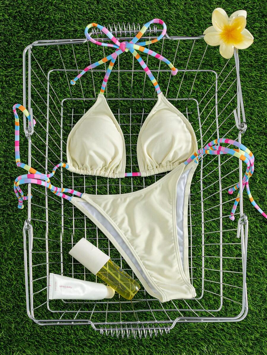 Women's striped halter bikini top with removable padding and matching tie-side low-waist swimsuit bottoms.