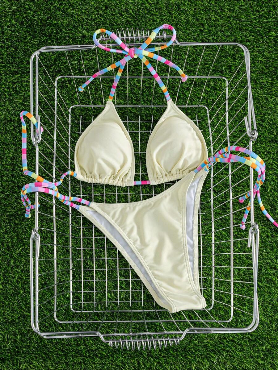 Women's striped halter bikini top with removable padding and matching tie-side low-waist swimsuit bottoms.