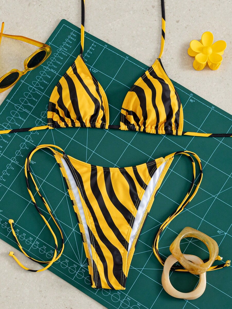 Women's striped halter bikini top with removable padding and matching tie-side low-waist swimsuit bottoms.