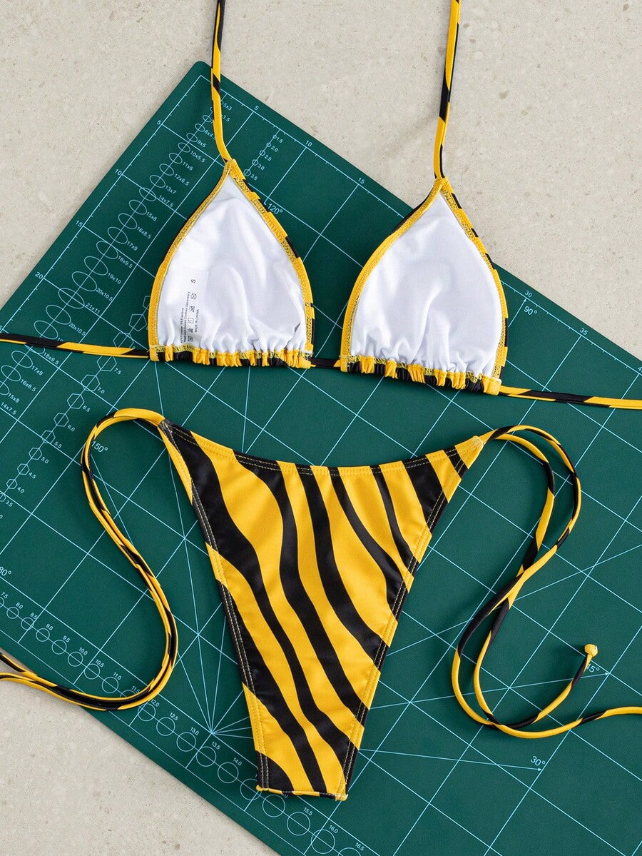 Women's striped halter bikini top with removable padding and matching tie-side low-waist swimsuit bottoms.