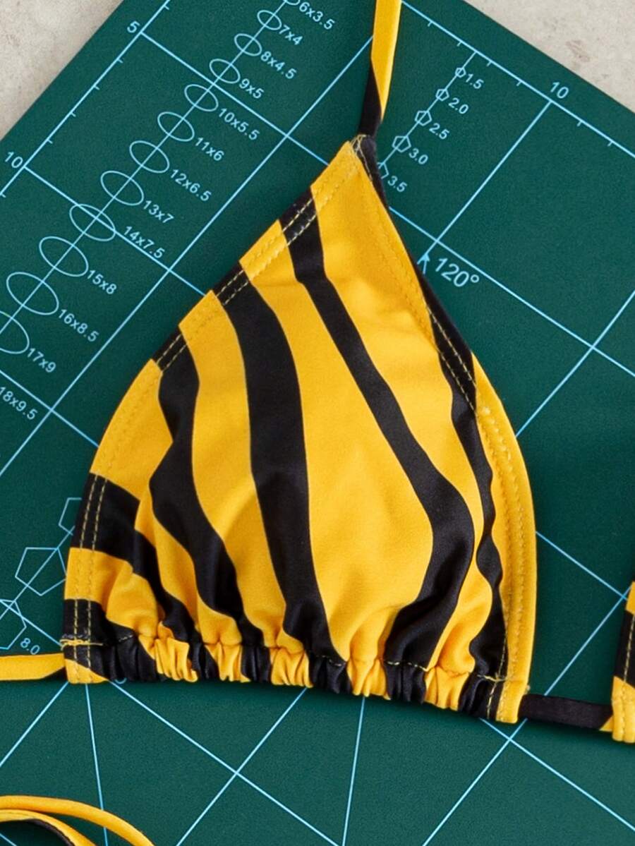 Women's striped halter bikini top with removable padding and matching tie-side low-waist swimsuit bottoms.