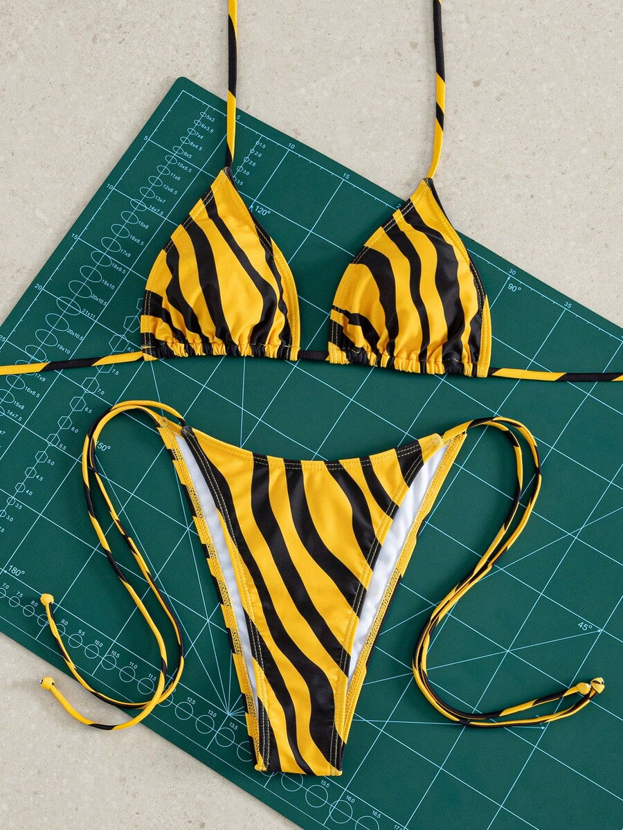 Women's striped halter bikini top with removable padding and matching tie-side low-waist swimsuit bottoms.