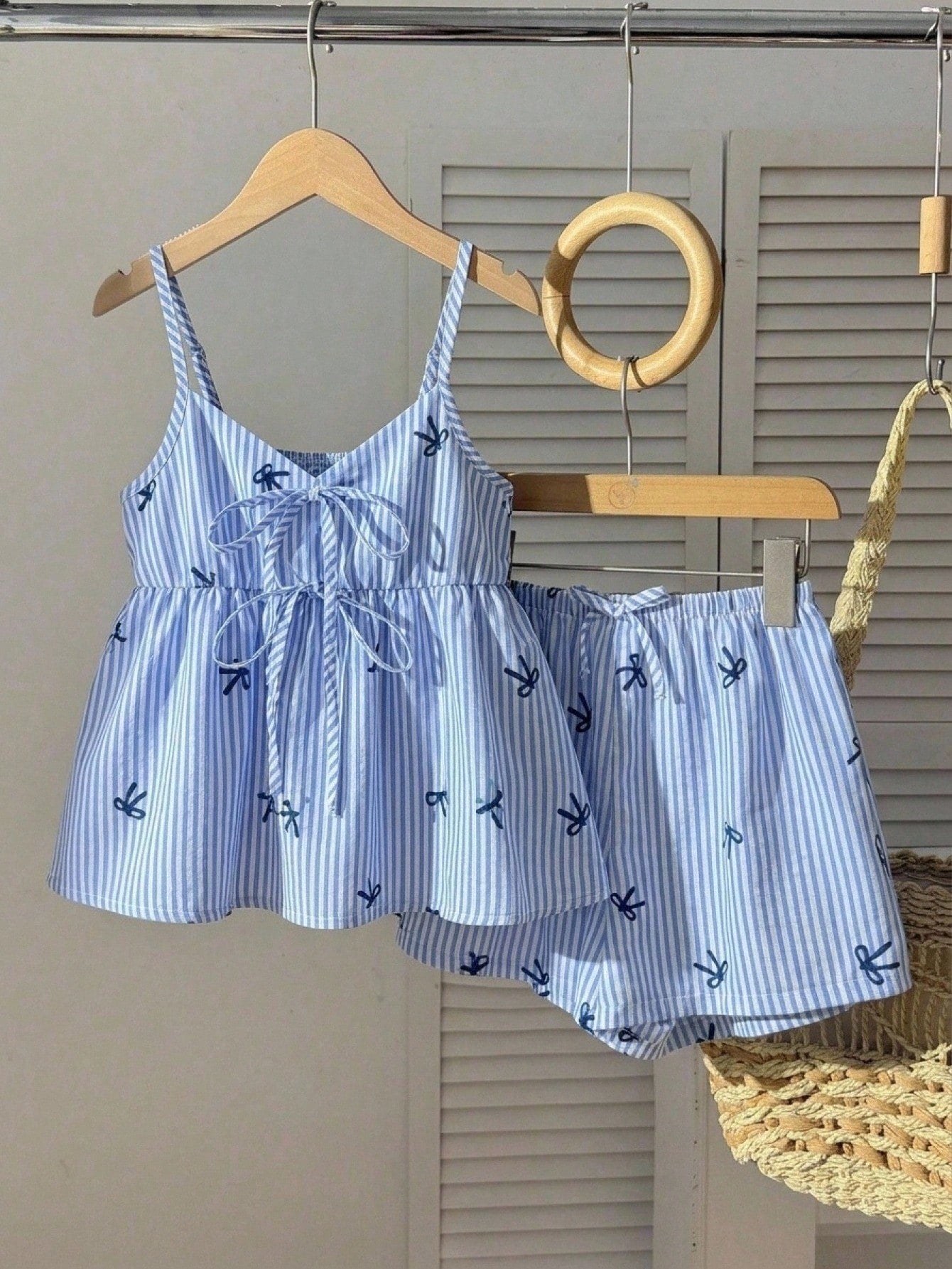 Tween girl 2-piece summer set with a black and white sleeveless striped spaghetti strap tank top with ruffle details and matching casual shorts.
