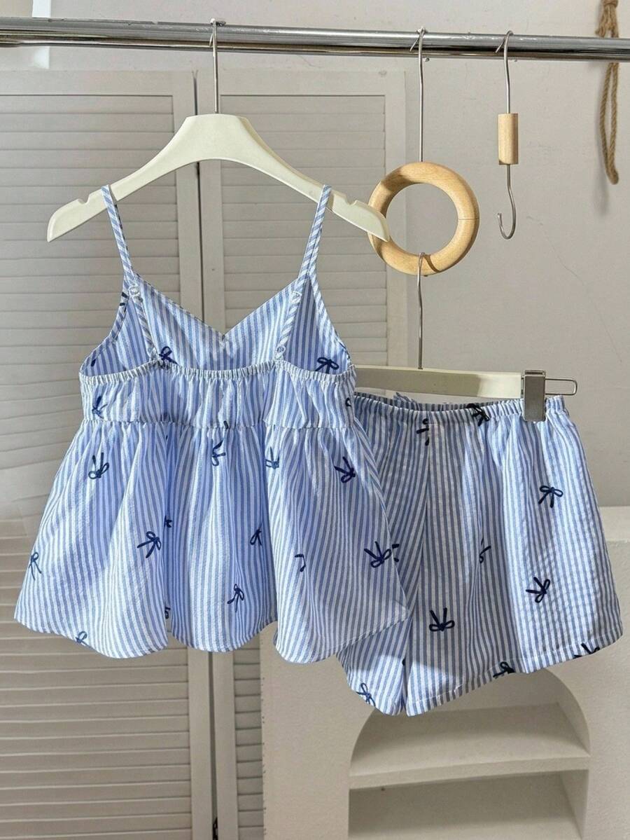 Tween girl 2-piece summer set with a black and white sleeveless striped spaghetti strap tank top with ruffle details and matching casual shorts.