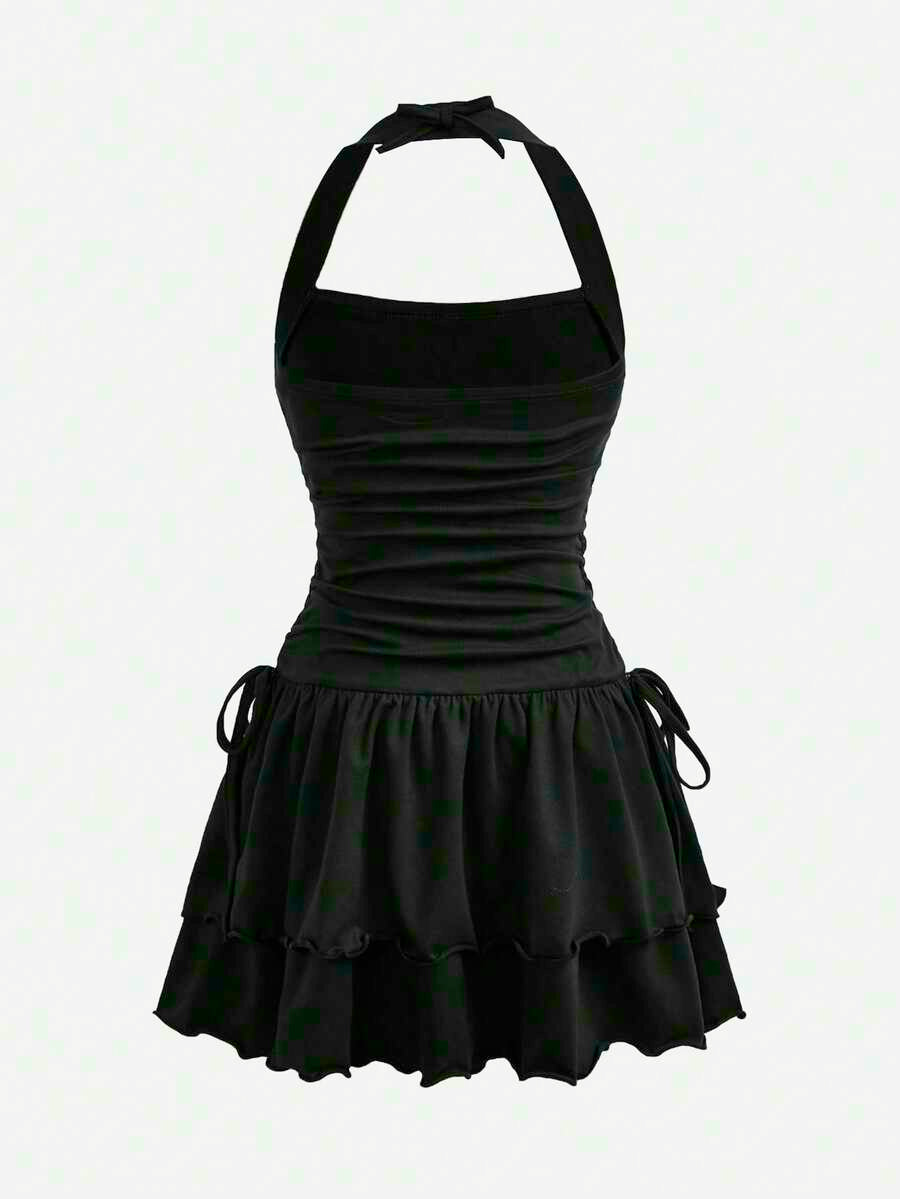 Black sleeveless halter polka dot mini dress for tween girls featuring a high waist and flared hem