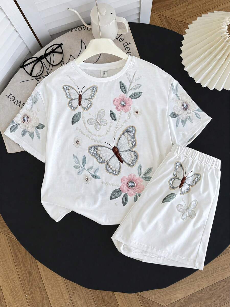Tween girl wearing a black and white striped drop-shoulder crew neck t-shirt with bow embroidery paired with matching tie-waist shorts.