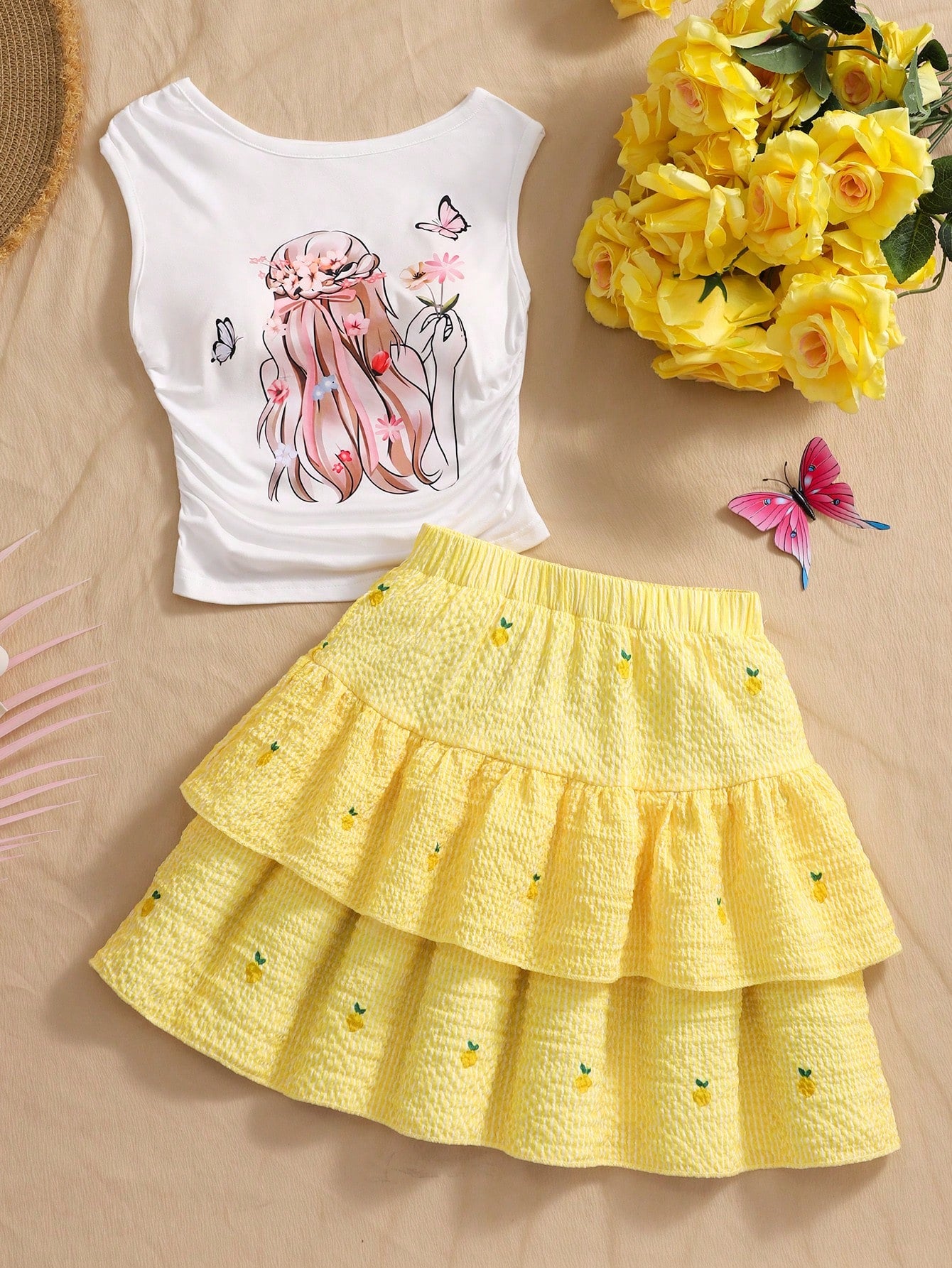 Light blue two-piece outfit set for tween girls with a sleeveless round neck vest top and a tiered ruffle cake skirt featuring a plant pattern.