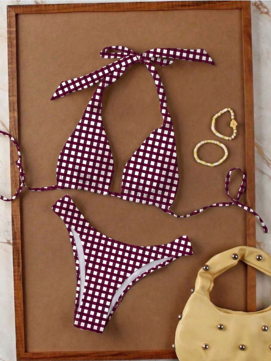 Women's halter neck bikini swimwear set featuring a wireless bra top with removable padding and mid waist bikini bottom.