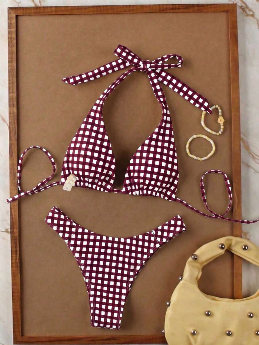 Women's halter neck bikini swimwear set featuring a wireless bra top with removable padding and mid waist bikini bottom.