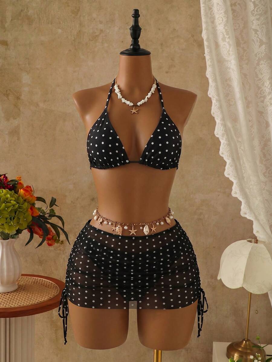 Women's black 3-piece bikini set featuring a halter triangle top with removable padding, high-waisted bottoms, and a knee-length mesh skirt with tie details.