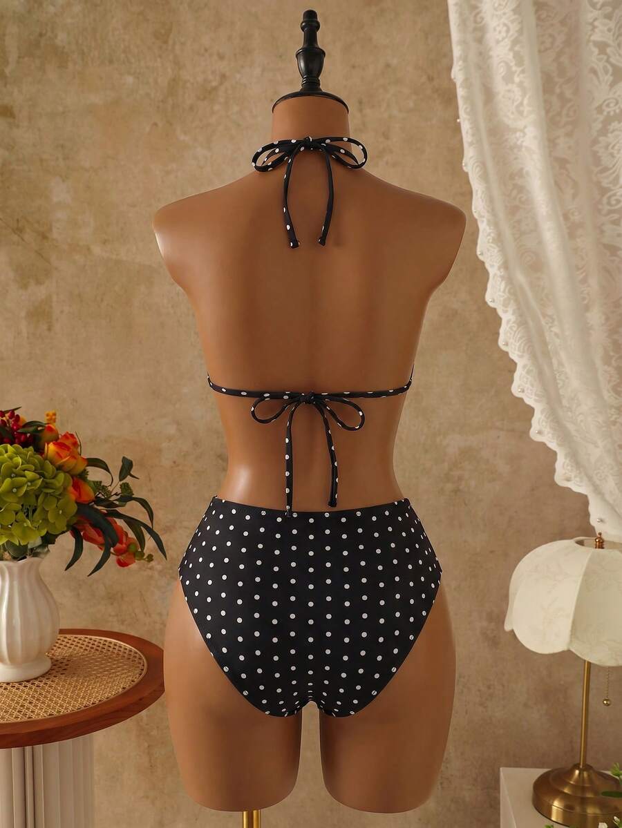 Women's black 3-piece bikini set featuring a halter triangle top with removable padding, high-waisted bottoms, and a knee-length mesh skirt with tie details.