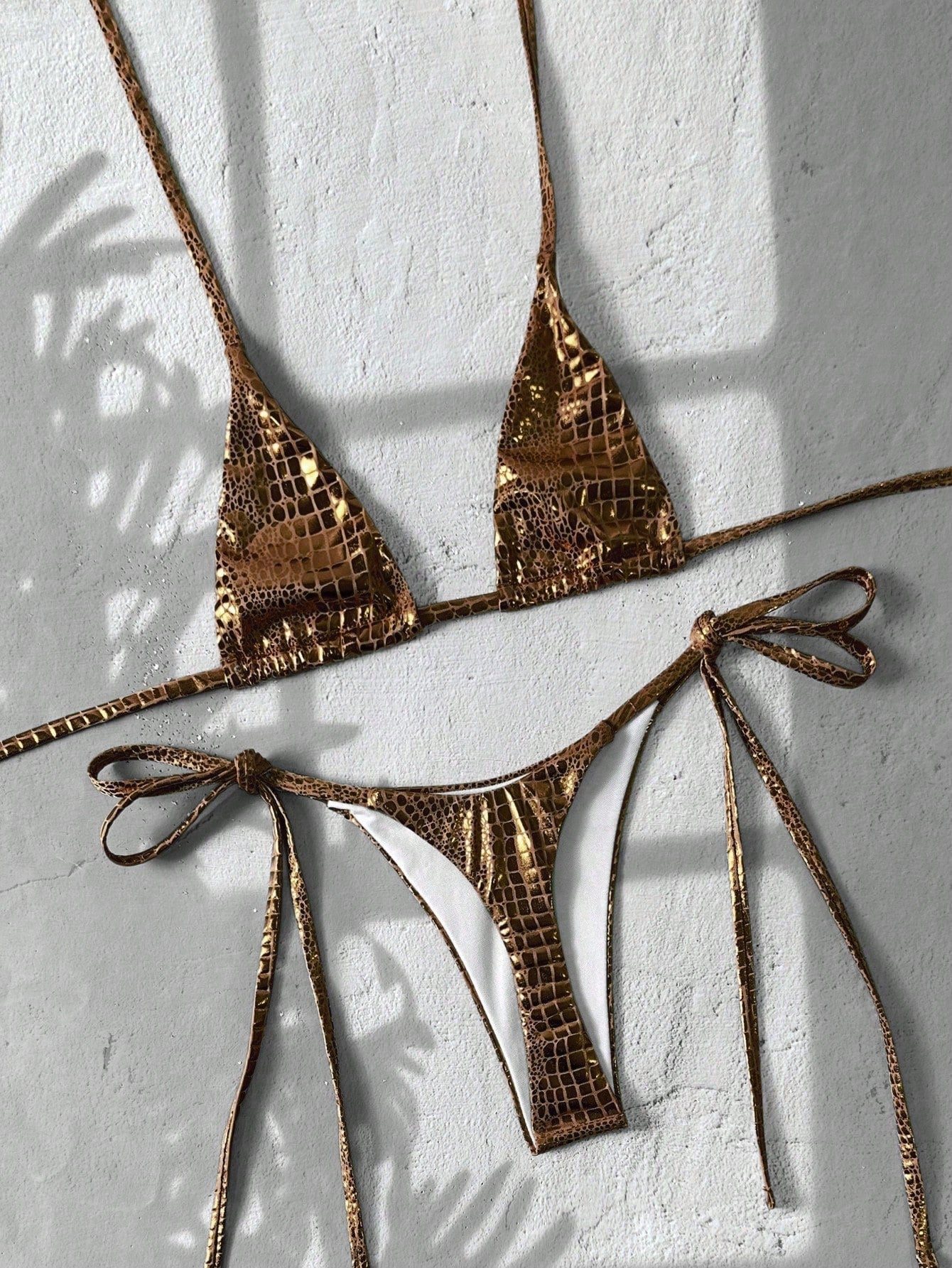 Black 2-piece snakeskin textured halter bikini set for women featuring high waist tie side bottoms and triangle cups.