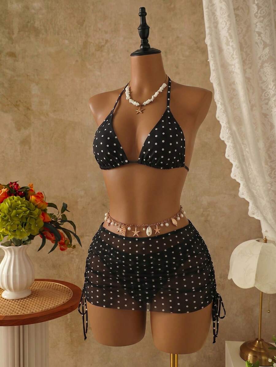 Women's black 3-piece bikini set featuring a halter triangle top with removable padding, high-waisted bottoms, and a knee-length mesh skirt with tie details.