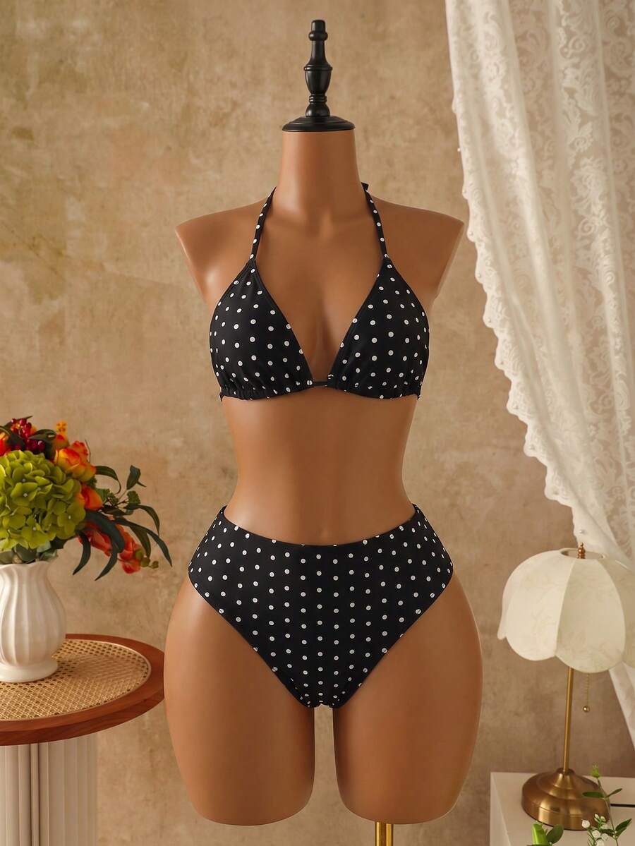 Women's black 3-piece bikini set featuring a halter triangle top with removable padding, high-waisted bottoms, and a knee-length mesh skirt with tie details.
