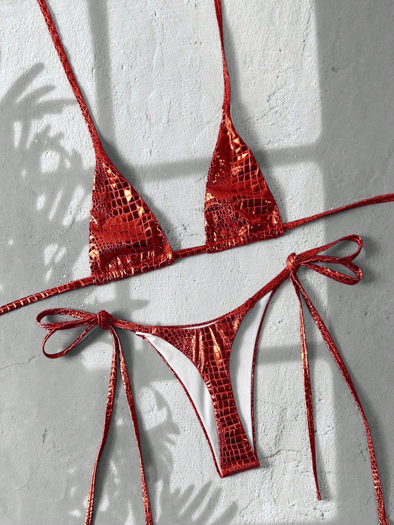 Black 2-piece snakeskin textured halter bikini set for women featuring high waist tie side bottoms and triangle cups.
