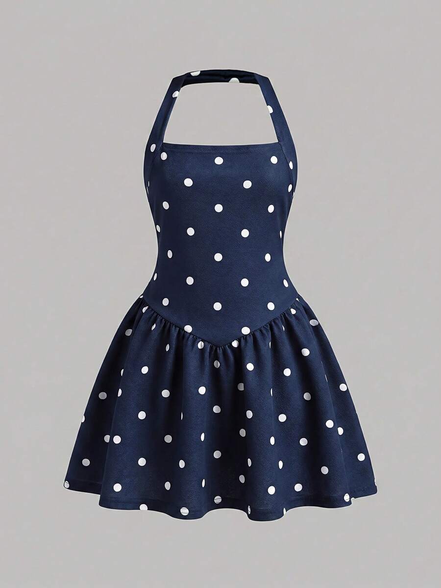 Black sleeveless halter polka dot mini dress for tween girls featuring a high waist and flared hem