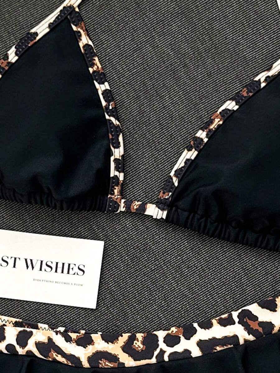 Women's 70s retro black and white polka dot bikini set featuring a halter triangle top and ultra low waist bottoms.