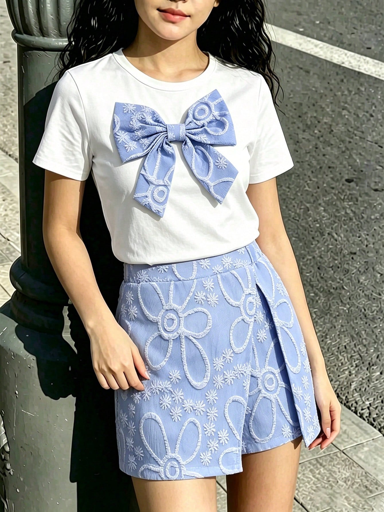 Tween girls 2-piece blue outfit featuring a short sleeve round neck t-shirt with a bow front detail and an asymmetric wrap skort.